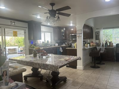 Bright kitchen area with a large table and modern appliances