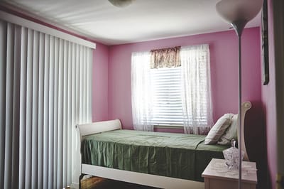 Cozy bedroom with pink walls and a bed