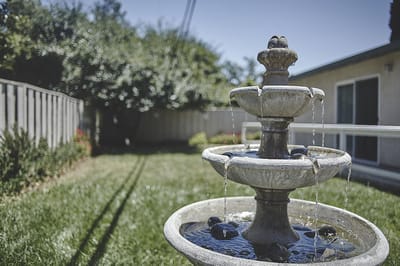 A decorative outdoor fountain in a garden