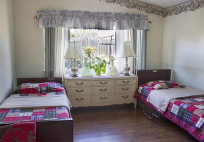 Cozy resident room with twin beds and floral decor