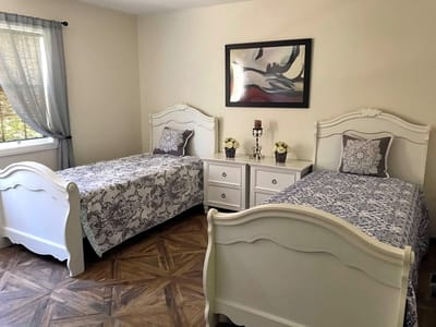 Cozy resident room with two beds and decor