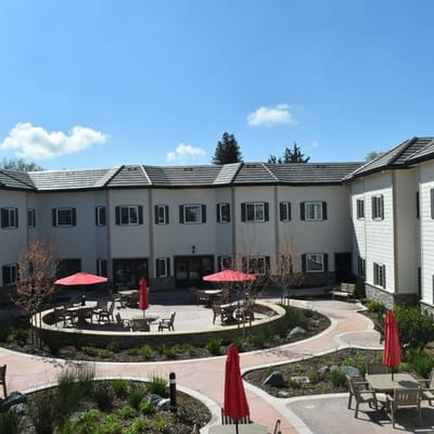Outdoor courtyard with seating and red umbrellas