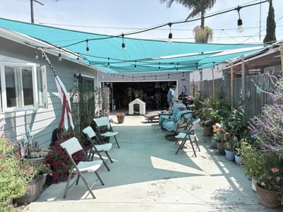 Outdoor seating area with flowers and a resident present