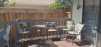 Outdoor seating area with floral chairs and tables