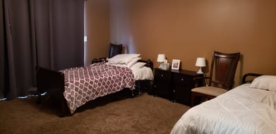 Interior view of a resident room with beds and furniture