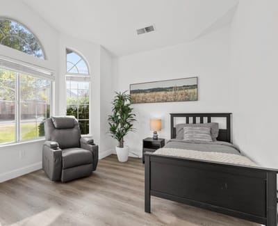 Cozy resident room with a bed and recliner
