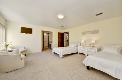 A well-furnished residential room with two beds