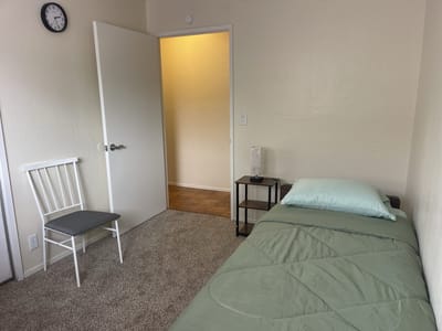 Simple resident room with a bed and chair