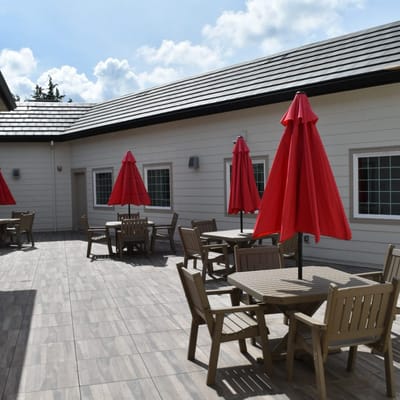 Outdoor seating area with red umbrellas and tables