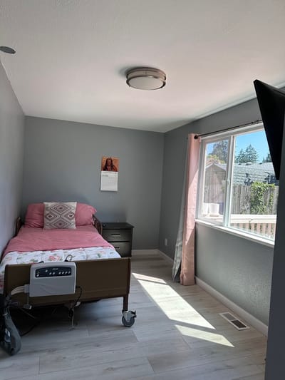 A cozy private resident room with a bed and window