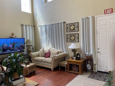 Cozy common area with seating and aquarium