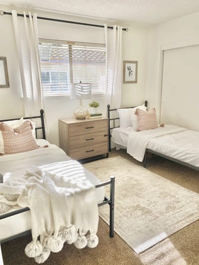 Bright shared room with two beds and decorations
