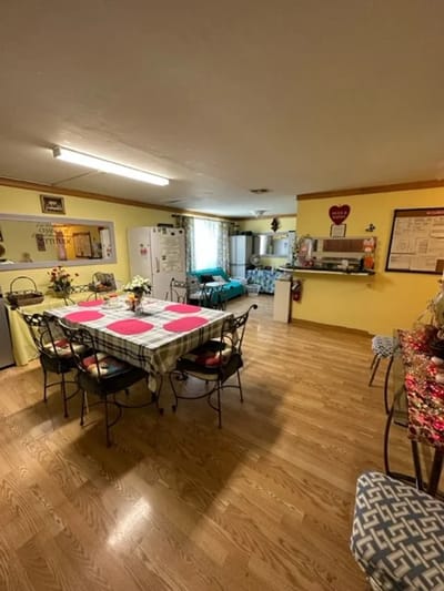 Bright common area with dining table and kitchen