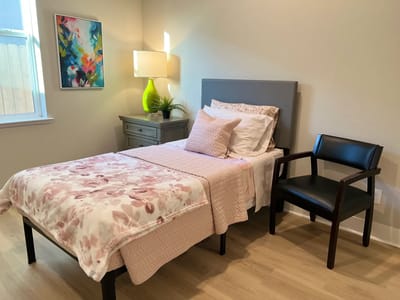 Cozy private resident room with a bed and chair