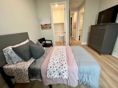Well-furnished private resident room with a large bed