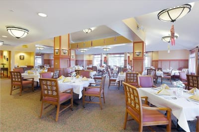 Bright dining room with tables set for meals