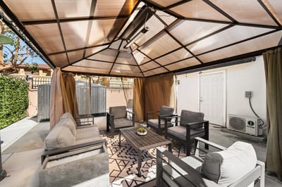 Outdoor seating area with a pavilion and furniture