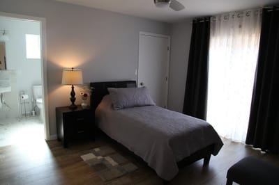 Cozy resident room with a bed and lamp