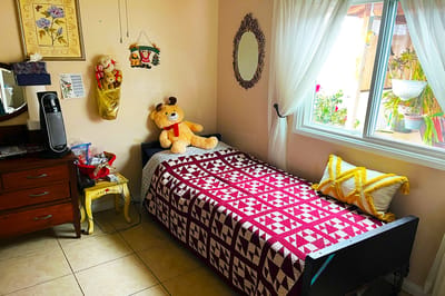 Cozy bedroom with a bed and a stuffed bear