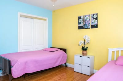 Simple bedroom setup with two beds and decor