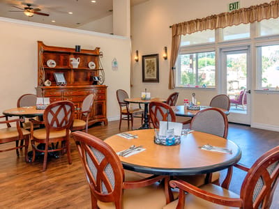 A dining area with wooden tables and chairs