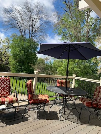 Outdoor patio area with seating and an umbrella