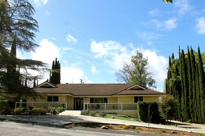 Exterior view of a yellow assisted living facility