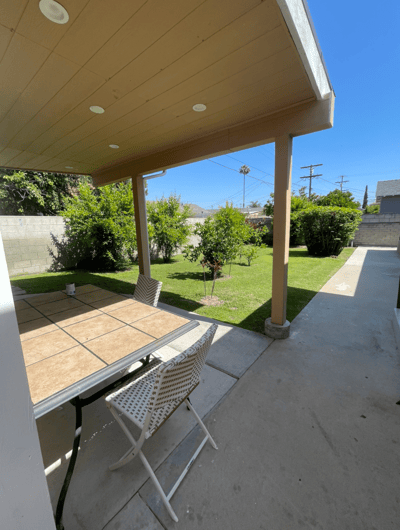 Shaded outdoor seating area with garden view