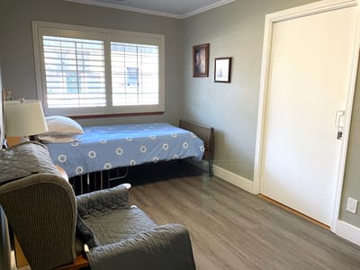 Cozy resident room with a bed and chair