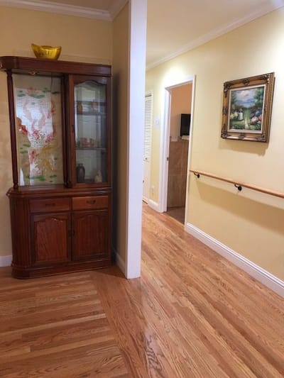 Interior view of a hallway with wooden flooring