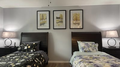 Two neatly arranged resident beds in a shared room