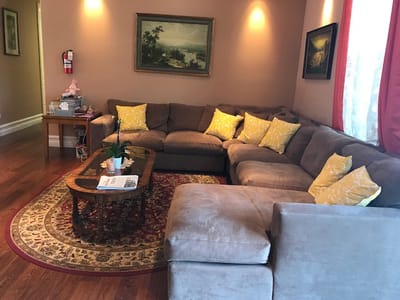 Cozy interior lounge with yellow cushions and paintings