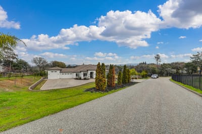 Exterior view of a senior living facility with surrounding landscape