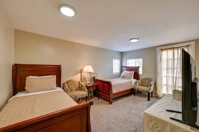 A shared resident room with two beds and decor