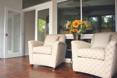 Two comfortable chairs in a bright common area