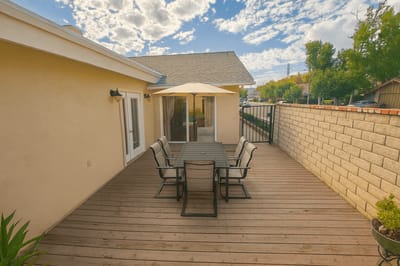 Patio area with table and chairs on a sunny day