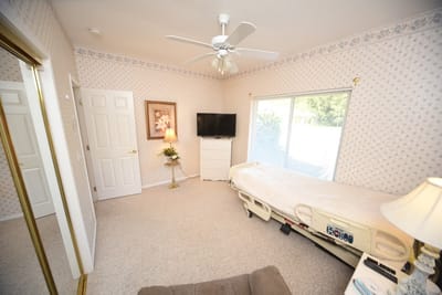 A private resident room with a bed and television