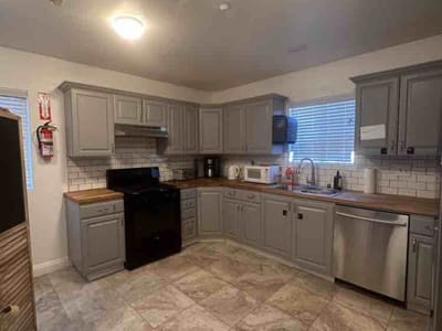Modern kitchen interior with gray cabinets and appliances