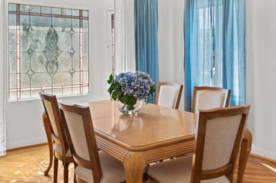 Bright common area with a dining table and flower centerpiece