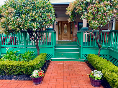 Entrance with well-maintained landscaping and decor