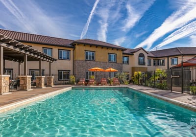 Outdoor pool area with seating and patio