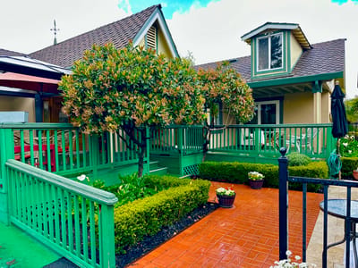Outdoor area with green railings and landscaped garden