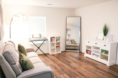 Bright and cozy lounge area with a keyboard and comfortable seating