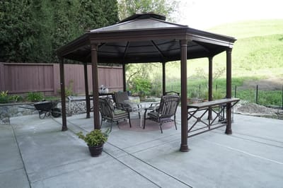 Outdoor gazebo with seating and greenery