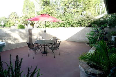 Outdoor patio area with a table and umbrella