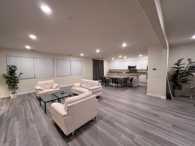 Bright common area with seating and kitchen view