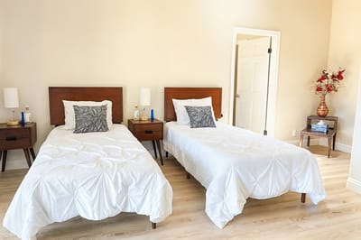 A cozy twin bedroom setup in an assisted living facility