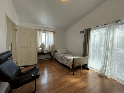 Private resident room with a bed and a chair