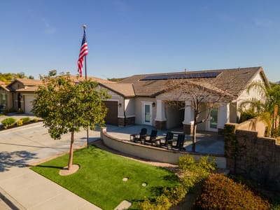 Exterior view of a senior living facility with outdoor seating