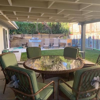 Outdoor patio area with seating and grill